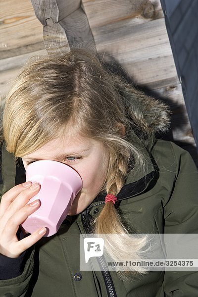 A girl having a break during a skiing day  Sweden.