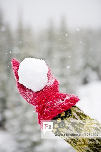 A woman making snowballs  Sweden.
