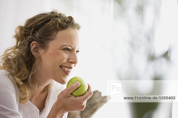 middle-aged woman eating a apple