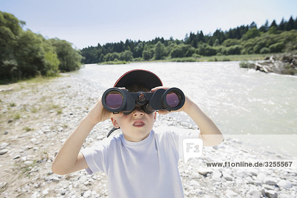 boy looking through field glasses