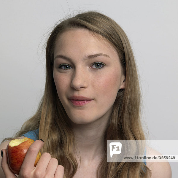 young woman eating an apple