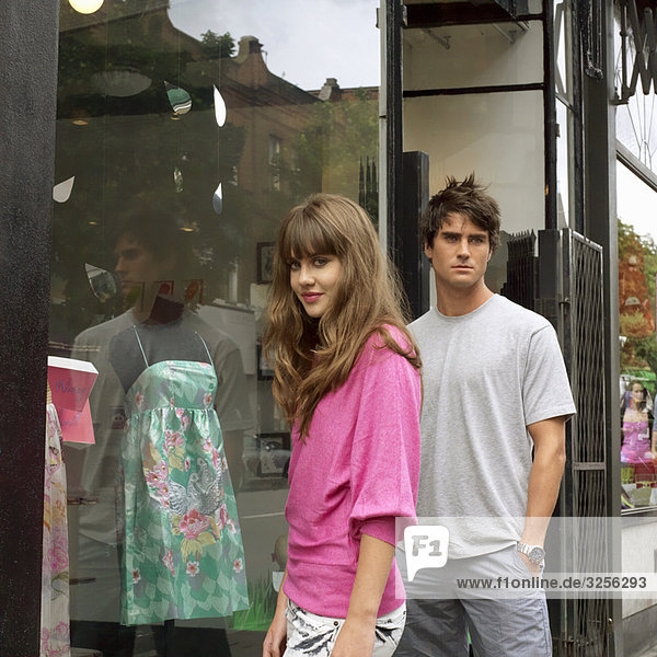 Young woman and man outside a shop