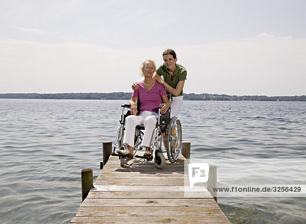 woman and senior woman in wheelchair