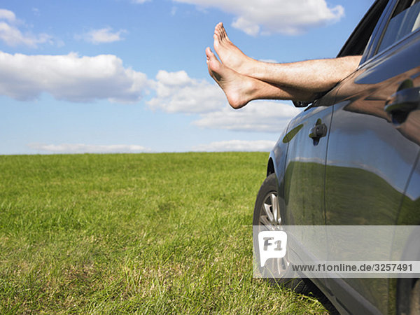 mans feet out of car window