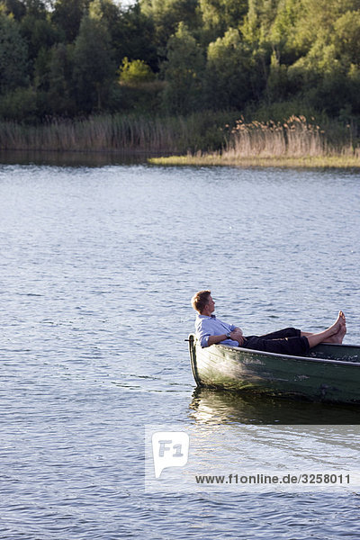 businessman relaxing in rowboat