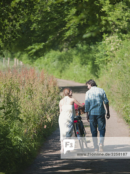 Man and woman walking up country lane