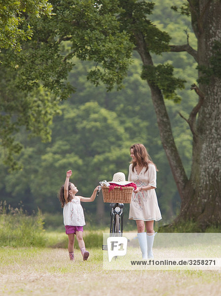 Mother and child with bike and picnic