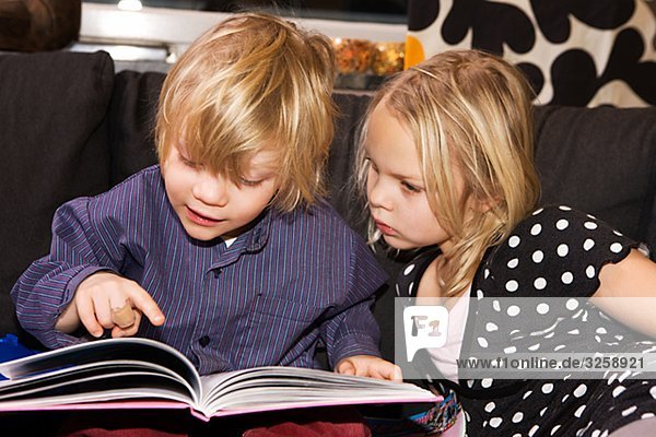 Children reading a book  Sweden.