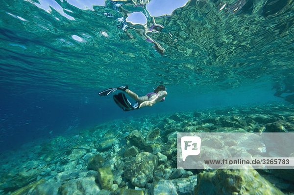 Croatia  Girl (10-11) snorkeling  rear view