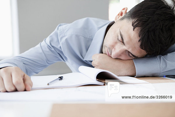 Businessman in office sleeping at workplace