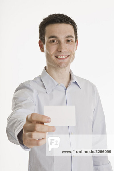 Businessman holding blank business card