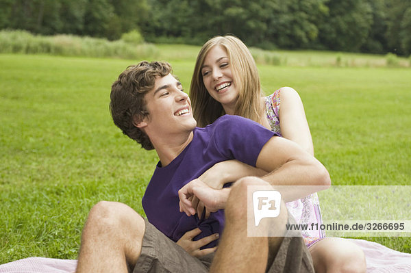 Germany  Bavaria  Starnberger See  Young couple in meadow having fun