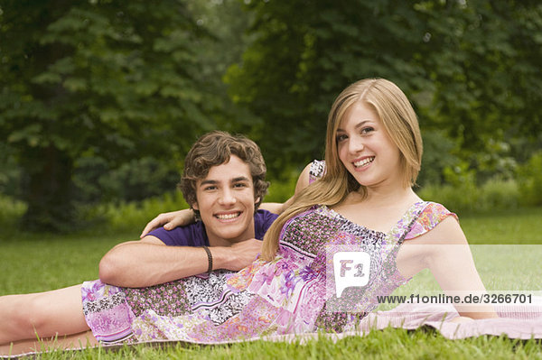 Germany  Bavaria  Starnberger See  Young couple lying in meadow