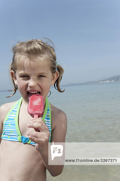 Spain  Mallorca  Girl (4-5) eating icecream on beach  portrait