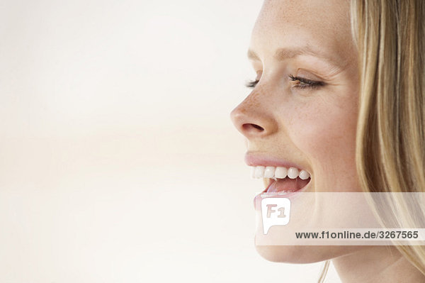 Young woman laughing  side view  portrait