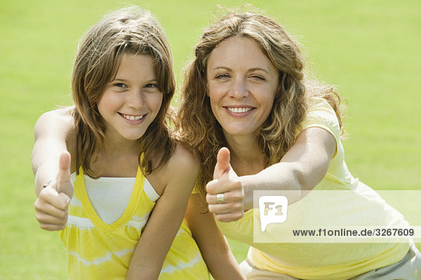 Spain  Mallorca  Mother and daughter (10-11)  thumbs up  smiling  portrait