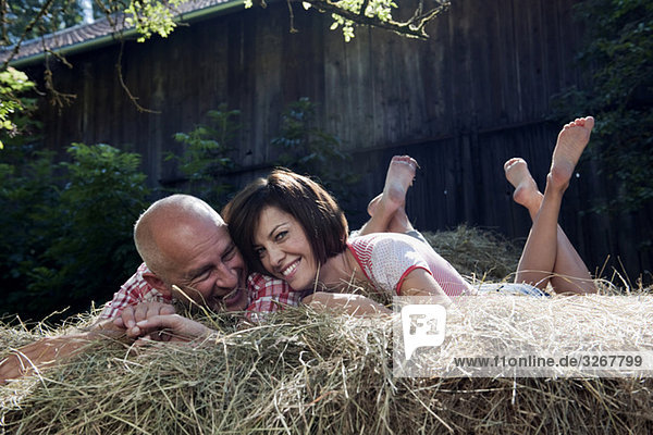 Germany  Bavaria  Couple lying on haystack