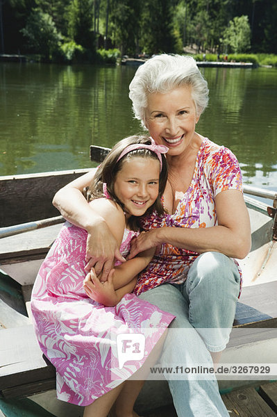 Italy  South Tyrol  Grandmother and granddaughter (8-9) sitting in rowing boat  smiling  portrait