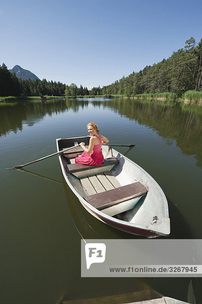 Italy  South Tyrol  Woman in rowing boat  smiling  portrait