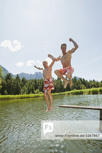 Italy  South Tyrol  Men jumping into lake  fooling about