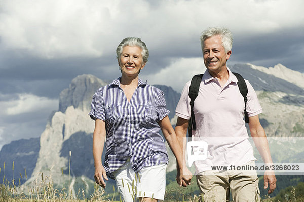 Italy  Seiseralm  Senior couple hiking hand in hand