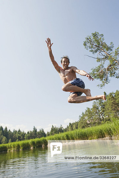 Italy  South Tyrol  Man jumping into lake