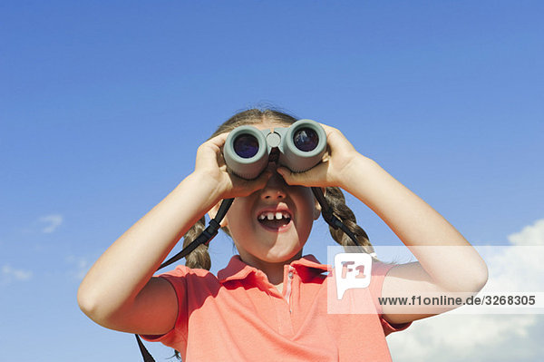 Italy  South Tyrol  Girl (6-7) using binoculars  portrait