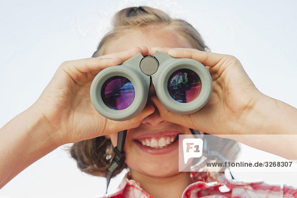 Italy  South Tyrol  Girl (10-11) using binoculars  portrait  close-up