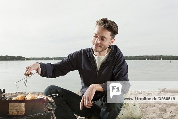 Lake Wannsee  Young man having a barbecue