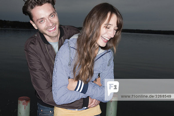 Germany  Berlin  Lake Wannsee  Young couple laughing  portrait