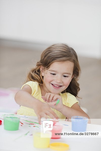 young girl playing with colours