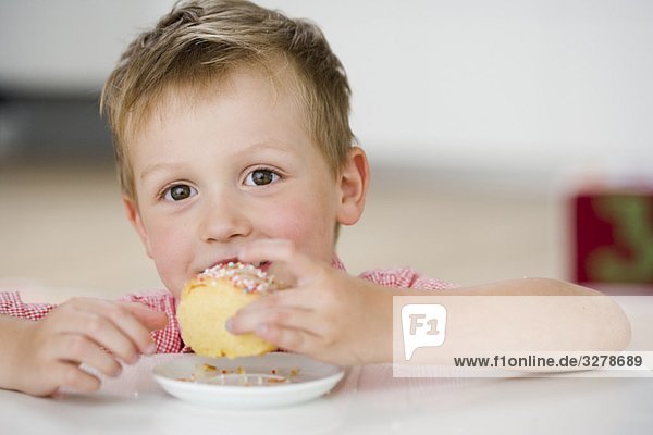 young boy eating sweet dumpling