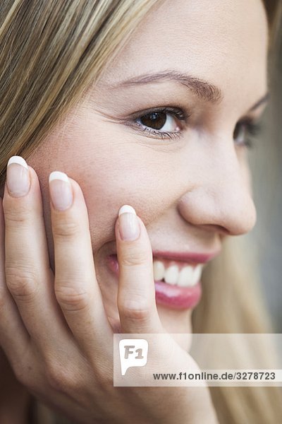 Young woman resting head on hand