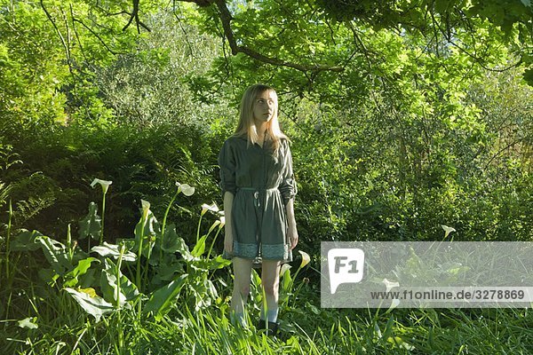 Young woman standing in garden