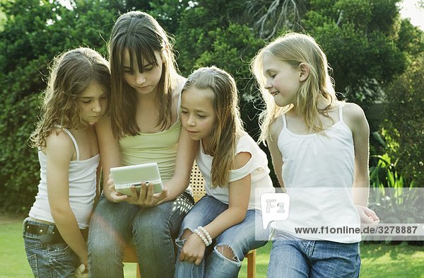 Group of girls playing with Gameboy