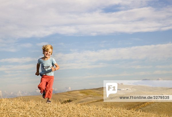 boy running across field