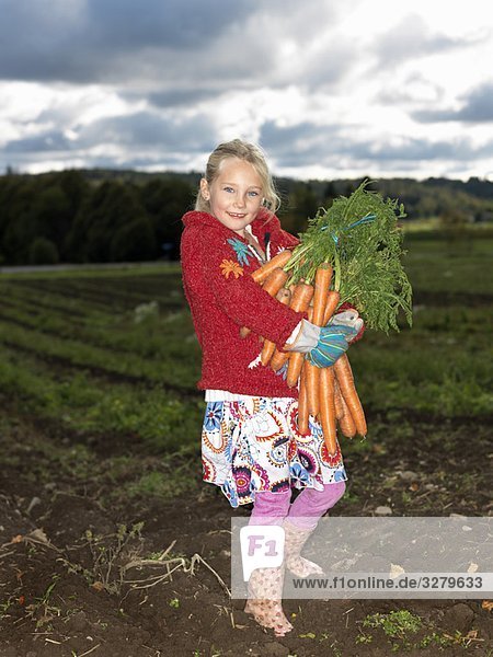 Girl with bunch of carrots