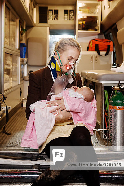 Young woman and baby in ambulance