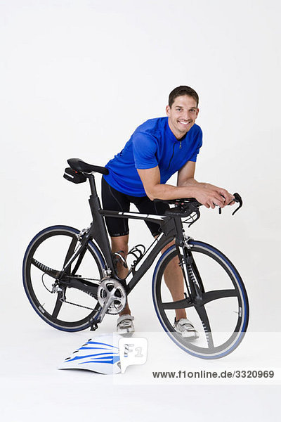 A man standing with a racing bike