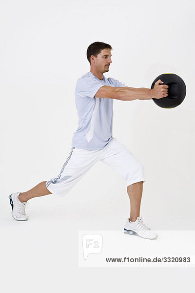 A man exercising with a medicine ball
