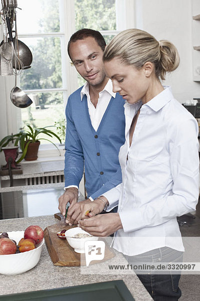 A couple preparing food in the kitchen