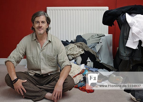 man with pile of clothes