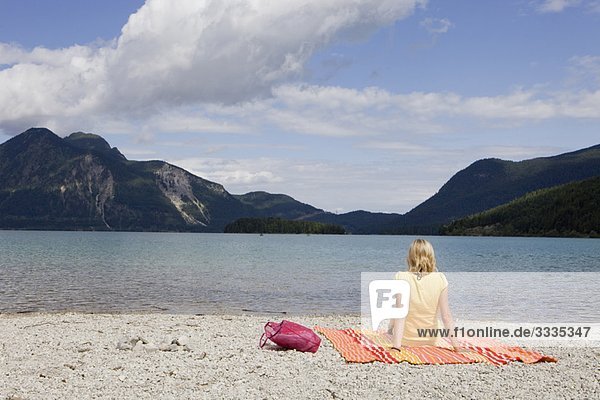 A girl relaxing on a beach towel