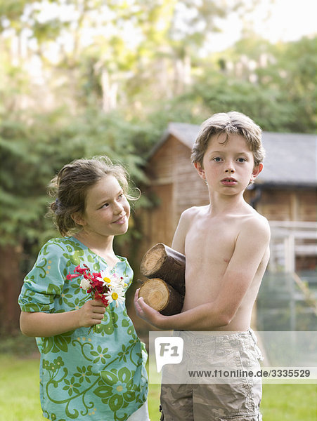 young boy and girl set up home in garden