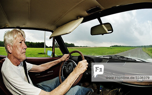 Man driving on dirt road in vintage Mercedes-Benz  Maricourt  Quebec