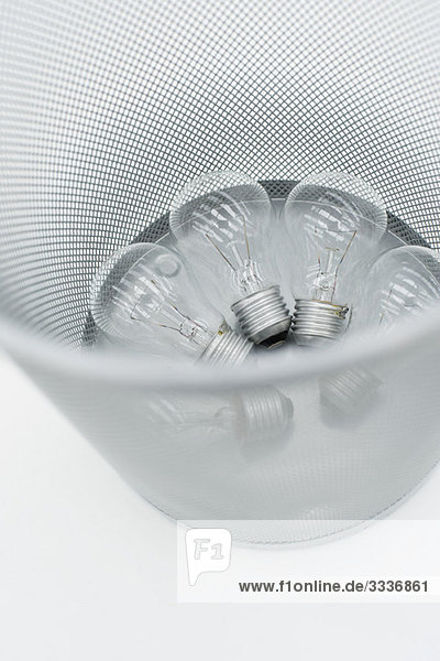 Conventional light bulbs in garbage can