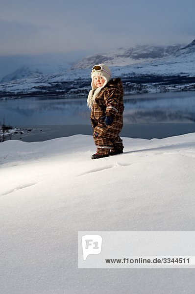 Little girl in front of a wintry mountain scenery  Sweden.