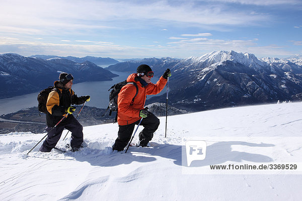 10870484  Switzerland  winter sports  snowshoe  snowshoeing  running  winter  snow  mountain  mountains  sport  spare time  adventure  canton Ticino  Ticino  south part of Switzerland  snowshoe  snowshoeing  Cimetta Lago Maggiore  persons  two  view  snowshoe  snowshoeing  tour