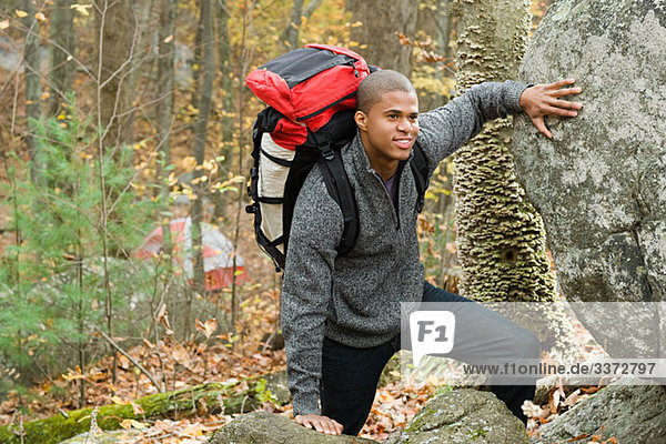 Young man in forest with backpack