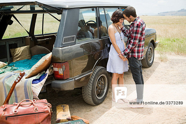 Young couple by suv